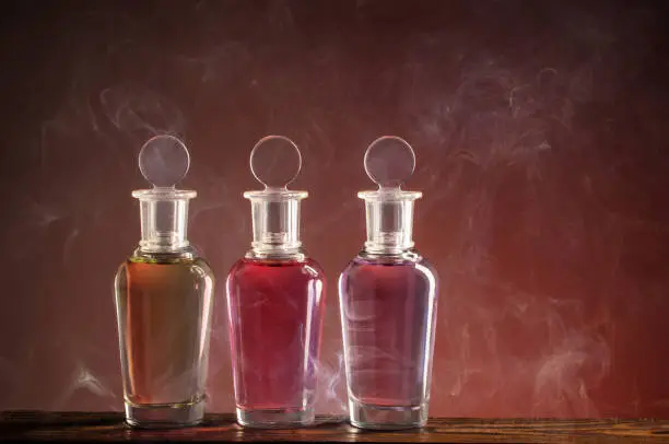 bottles with magic potion in smoke