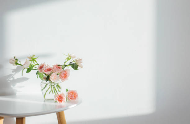 istock pink roses in glass jar on white modern table on background white wall 1378704059