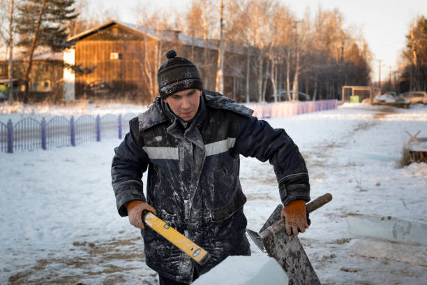 istock Builder with a tool in his hands at the construction site of the ice town 1378718444