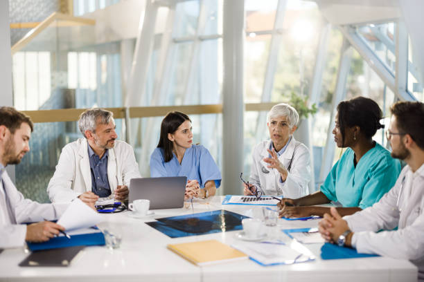 istock Team of general practitioners talking on a meeting at doctor's office. 1378734640