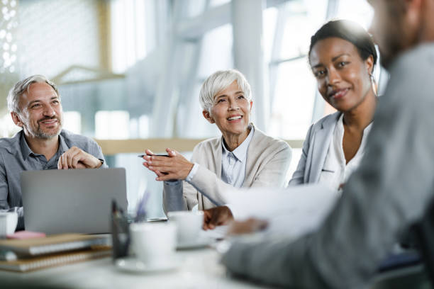 istock Happy entrepreneurs talking during a constructive meeting in the office. 1378736820