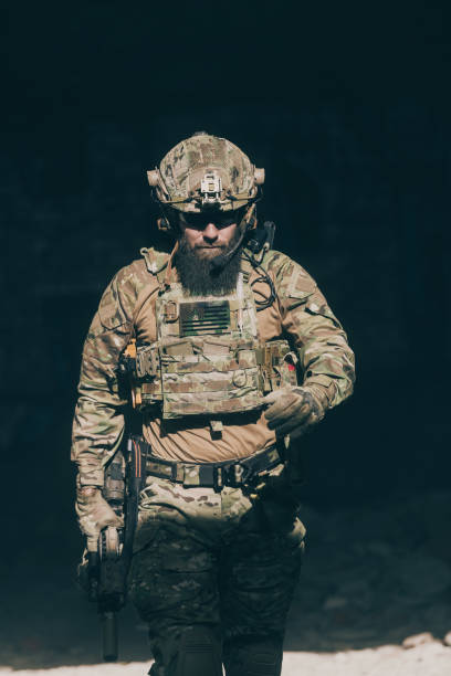 istock A bearded soldier in a special forces uniform walks through an abandoned building after a successful mission. Selection focus 1378743263