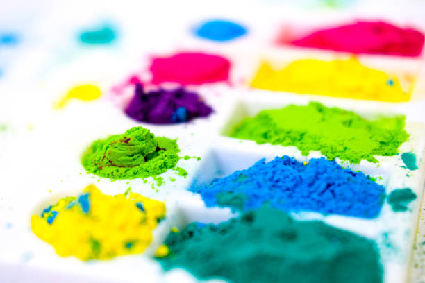 Multicolored holi paints in a palette on a white background . High quality photo