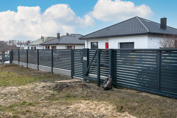 istock Modern panel fencing in anthracite color, visible spans and a gate with a letterbox, view from the garden. 1378754089