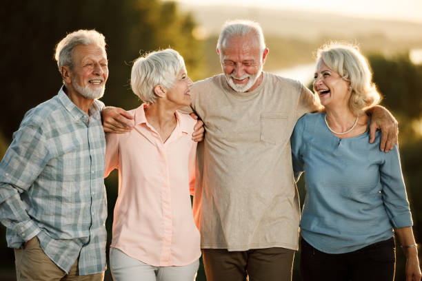istock Cheerful senior friends walking embraced in nature. 1378763852