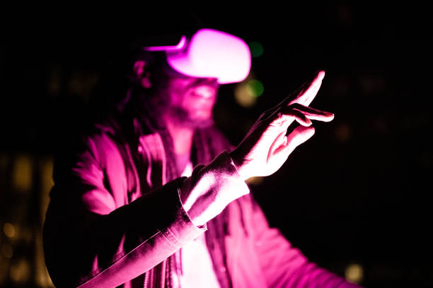 istock Young hacker using vr goggles for surfing the deep web and acting secretly from the authorities, player using head set for virtual reality, gesturing on virtual pad, augmented reality and meta verse world technology concept 1378772667