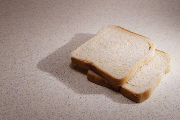 Two pieces of toast bread on kitchen desk.
