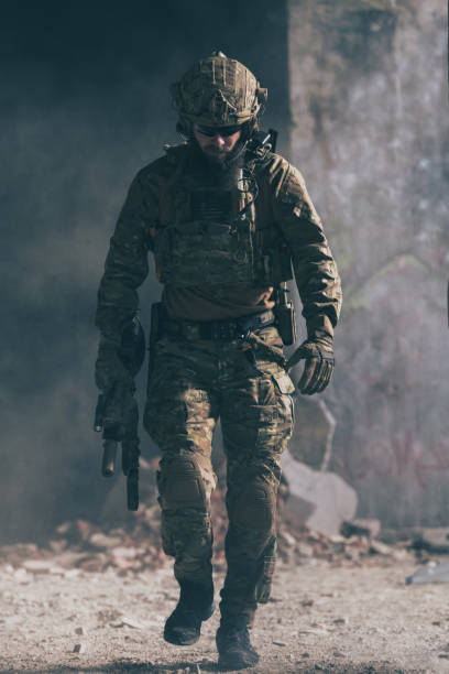 istock A bearded soldier in a special forces uniform walks through an abandoned building after a successful mission. Selection focus 1378778124