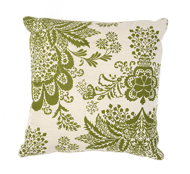 Green and white couch pillow with a floral pattern stock photo