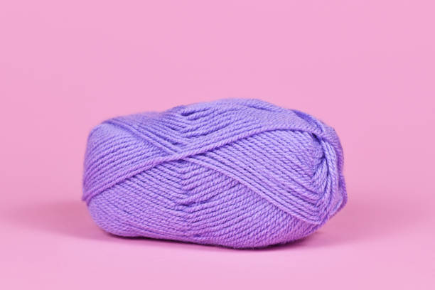 istock Violet ball of wool on pink background 1378783580