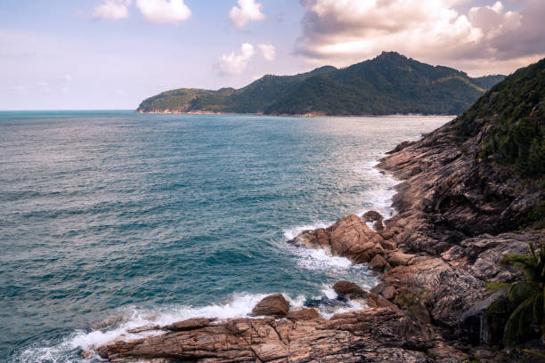 istock Wild place, stone shore, top view, turquoise sea waves at sunset 1378796861