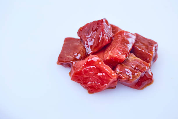Raw beef cook with sauce sliced on white background