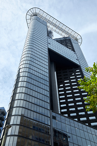 Low angle view of modern glass skyscraper in The Hague, Netherlands