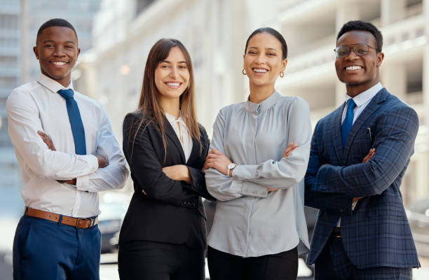 Shot of a group of lawyers standing in the city We fight injustice with a smile lawyer stock pictures, royalty-free photos & images