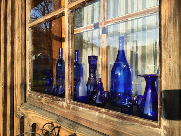 istock Vintage blue bottles in wooden window. 1378827585