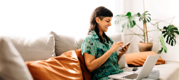 istock Cheerful young freelancer reading a text message at home 1378828112