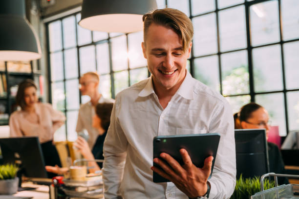 istock Smiling businessman on video call using digital tablet 1378831811