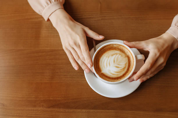 istock A womans hands hold a cup of coffee 1378834002