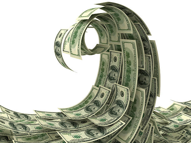 Lots of dollar notes forming a tidal wave stock photo
