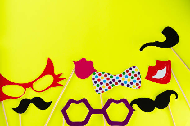 istock Top view image of funny masks on yellow background 1378858515