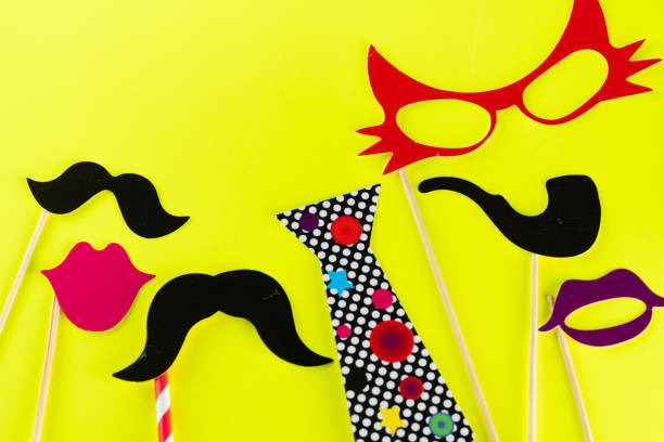 istock Top view image of funny masks on yellow background 1378862995