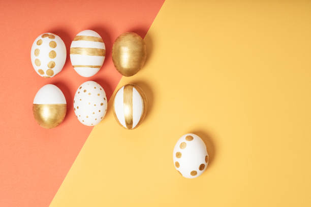 istock Hand-drawn easter eggs on yellow and orange pastel background. Many easter eggs flat lay background. 1378864841