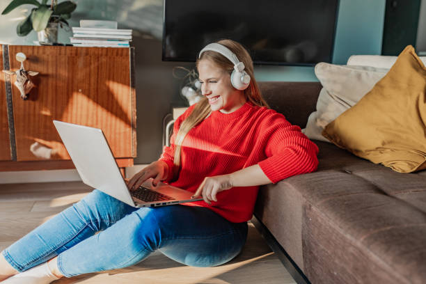 istock Beautiful woman is using laptop at home 1378866661