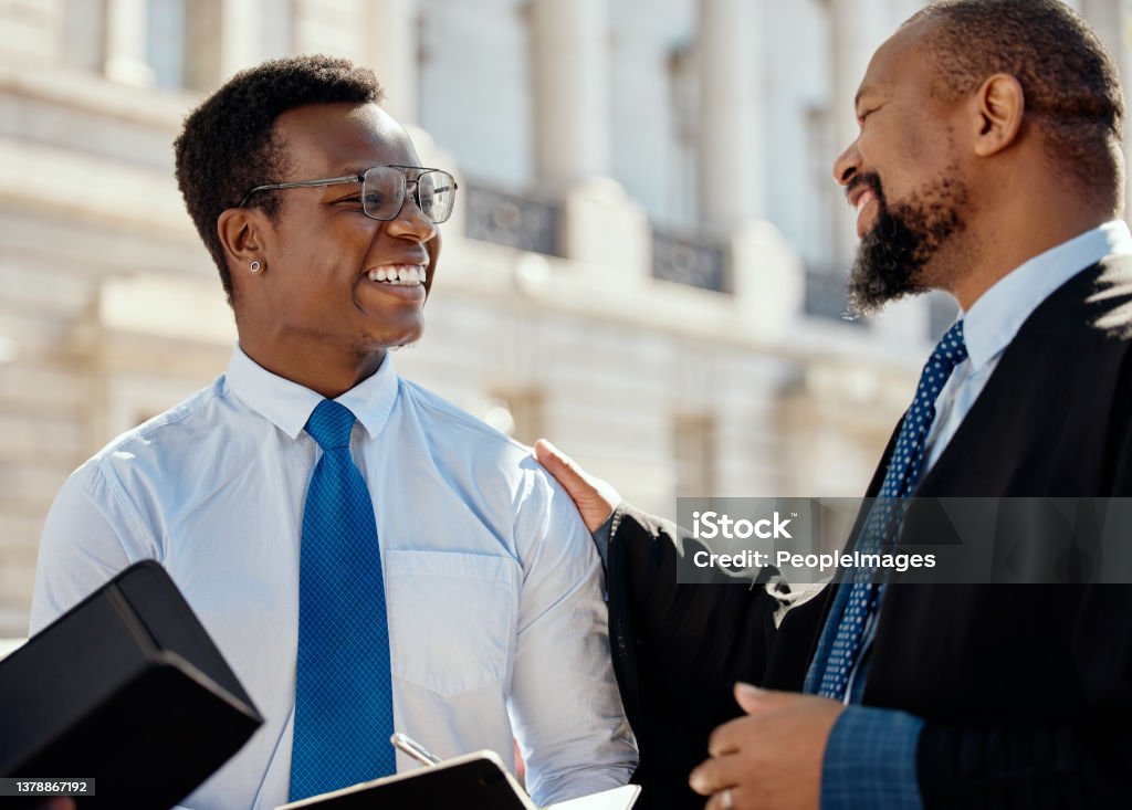 Shot of two lawyers talking in the city He's got the best mentor Mentorship Stock Photo