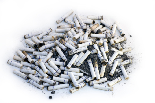 Cigaret butts seen from above on a white background