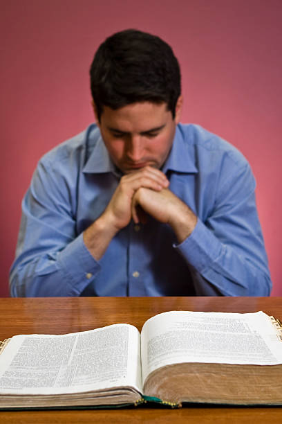 istock Man prays. Bible in focus 137888085