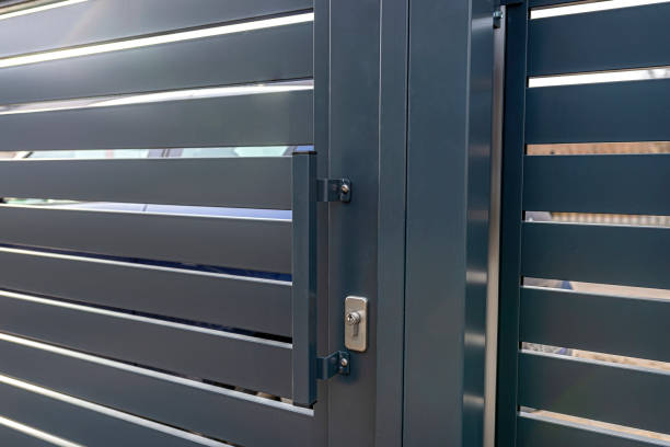 istock Modern anthracite panel fence, visible sliding gate to the garage, visible handle and lock. 1378890240