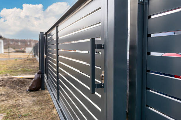 istock Modern anthracite panel fence, visible sliding gate to the garage, visible handle and lock. 1378891306
