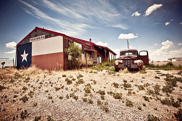 Abandoned restaraunt and old style car near gas station on the famous route 66 road in USA
