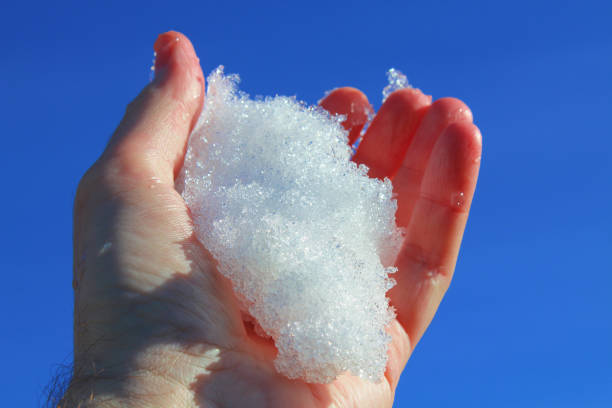 istock Cold snow in a man's hand. Close-up. Background. 1378914360