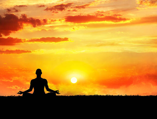 Yoga meditation at sunset stock photo