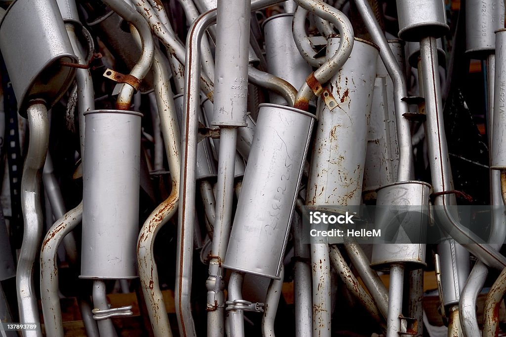 Car Exhaust Pipes Lot of exhaust pipes stacked in absolutely no order Air Pollution Stock Photo