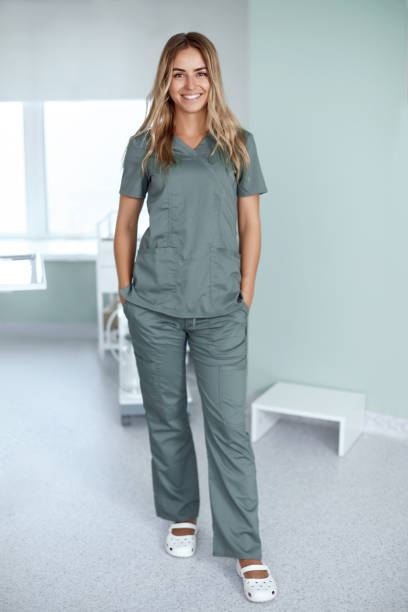Smiling female doctor in hospital corridor. Patients consultation. stock photo