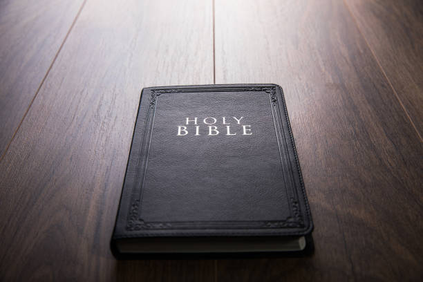 istock Holy Bible on wooden table. 1378951828
