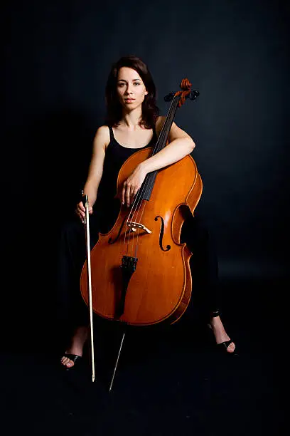 Dramatic photo of beautiful cellist