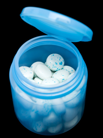 Open plastic container of Mint Chewing gum from above on black background (this picture has been taken with a super high definition Hasselblad H3D II 31 megapixels camera)