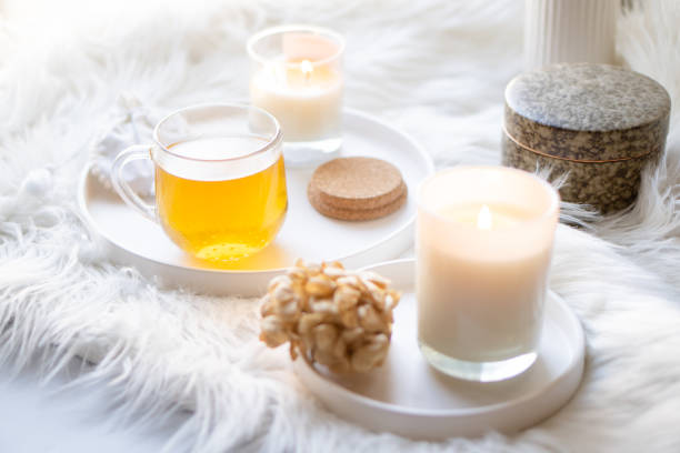 istock Cup of herbal tea and burning candle on round white decorative tray 1378968236