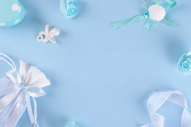 istock Flat lay layout with baby boy clothes, ceramic nipple or baby's dummy, gift box for baby shower party 1378968257