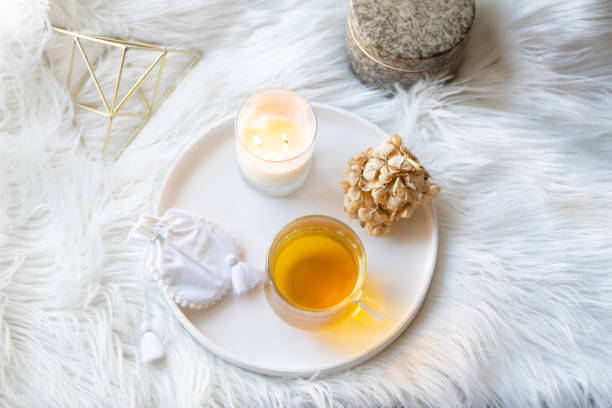 istock Cup of herbal tea and burning candle on round white decorative tray 1378968785