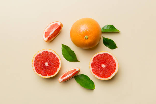 istock fresh Fruit grapefruit with Juicy grapefruit slices on colored background. Top view. Copy Space. creative summer concept. Half of citrus in minimal flat lay with copy space 1378974213