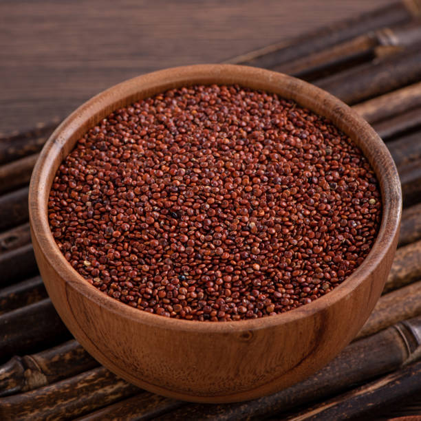 istock Organic red quinoa in a bowl on wooden table background. 1378982763