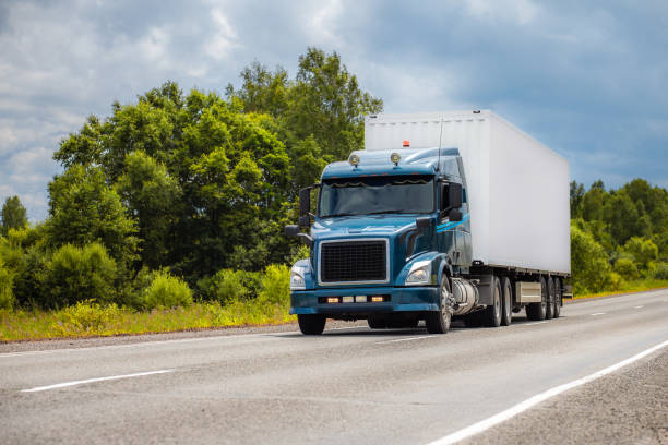 istock Blue truck on a road in summer 1378983329