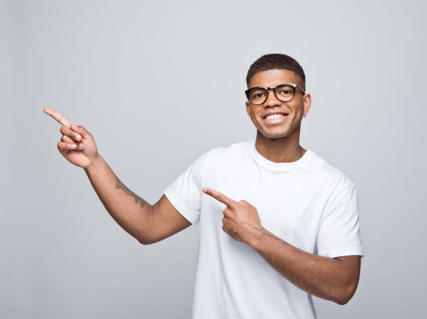 istock Cheerful young man pointing at copy space 1378990068