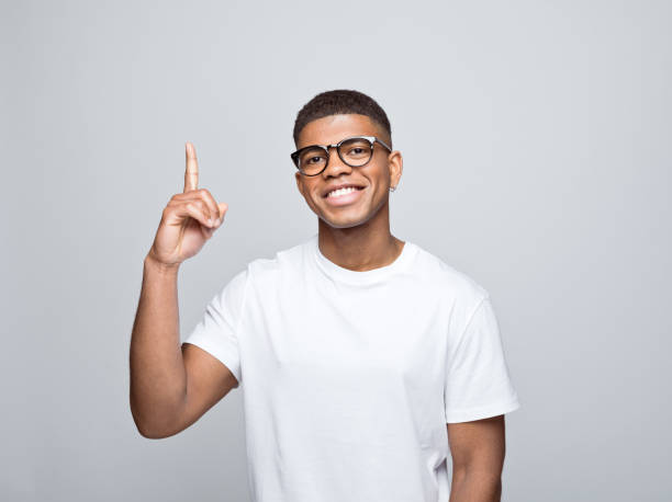 istock Cheerful young man pointing at copy space 1378990260