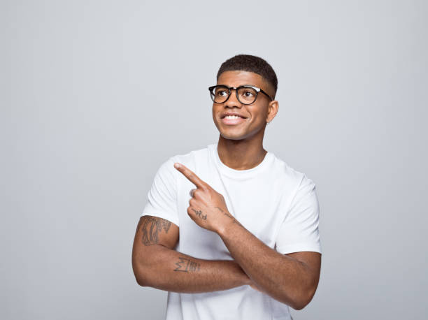 istock Cheerful young man pointing at copy space 1378990797