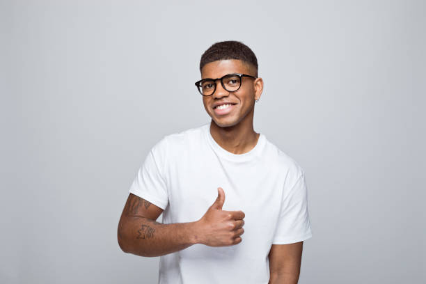 istock Cheerful young man standing with thumb up 1378991190